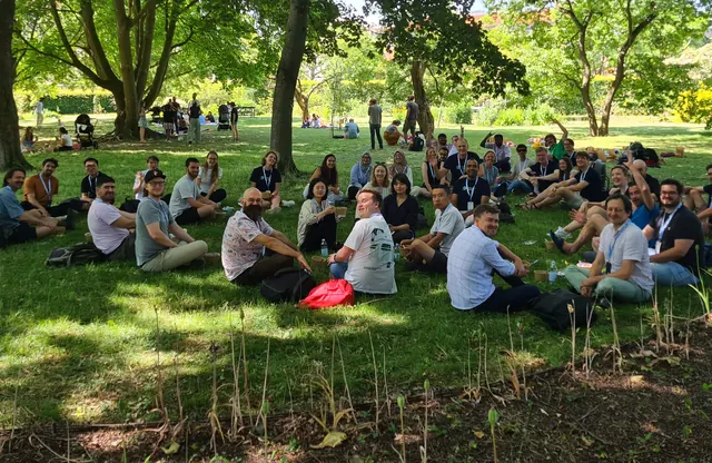 Participants having lunch on the grass in a park